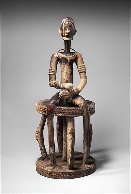 Seated binukedine ( priest), by Dogon blacksmith