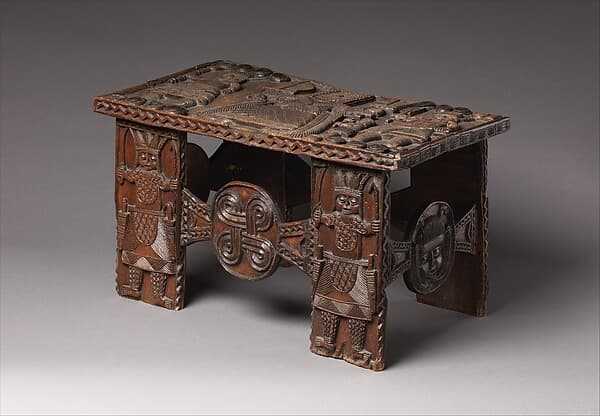 Agba (stool) with ọ́bà with mudfish legs, by Omada (sword bearer and wood carver) association member(s)