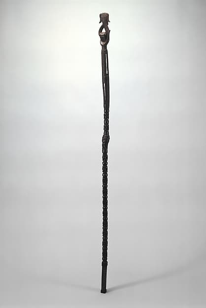 Ukhurhe (rattle staff) with hand holding mudfish, by Ìgùn Ẹ́rọ̀nwwọ̀n (brass-casting guild) artists
