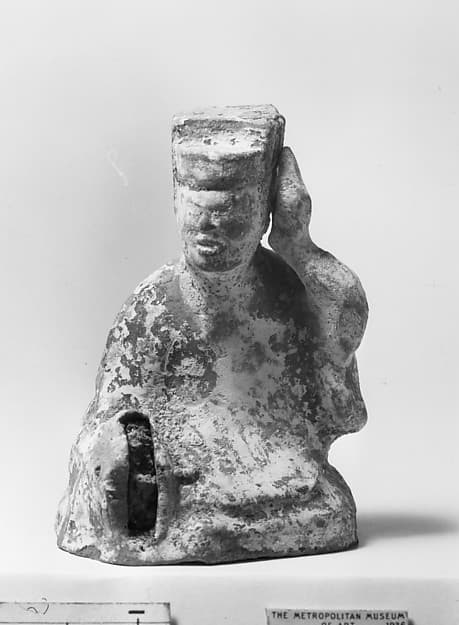 Figure of a seated musician