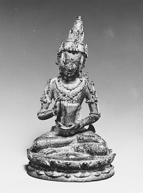 Seated Male Deity Holding a Cuirass (Chest Armour)