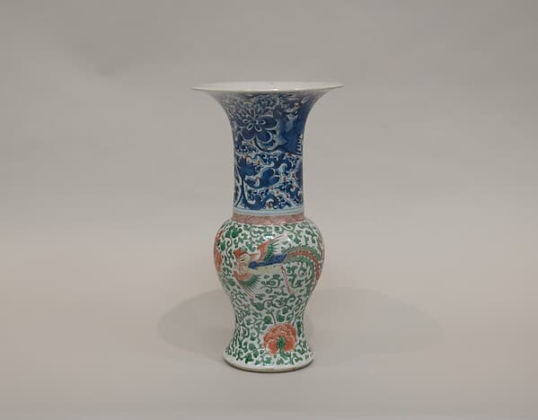 Vase with phoenixes amid flowers