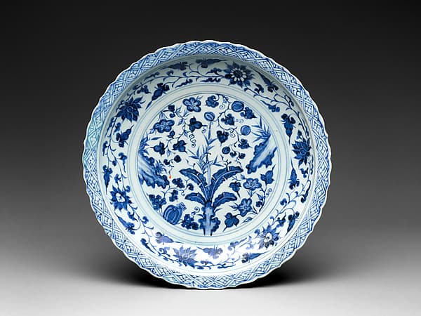 Foliated plate with rocks, plants, and melons