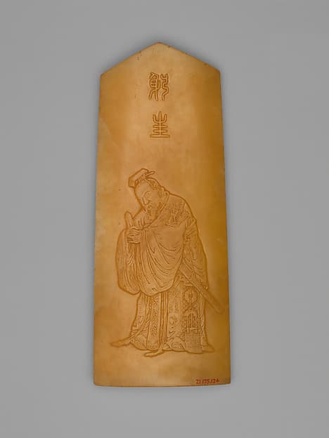Armrest in the shape of an archaic tablet