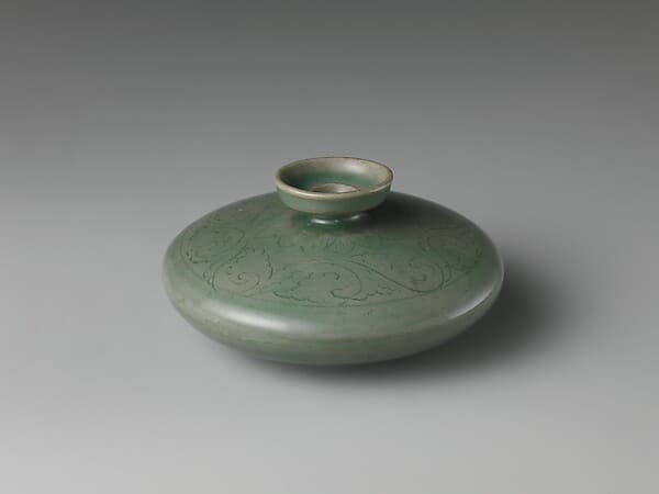 Oil bottle decorated with floral scrolls and lotus petals