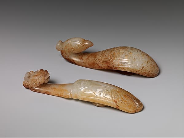 Two belt hooks with archaistic patterns