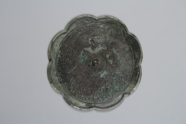 Mirror decorated with palmette and arabesque motifs