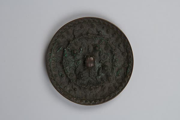 Mirror with fantastic animals amid grape vines