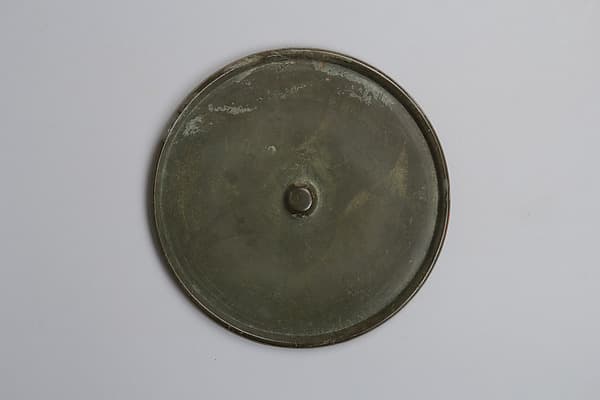 Mirror with incised Buddhist triad