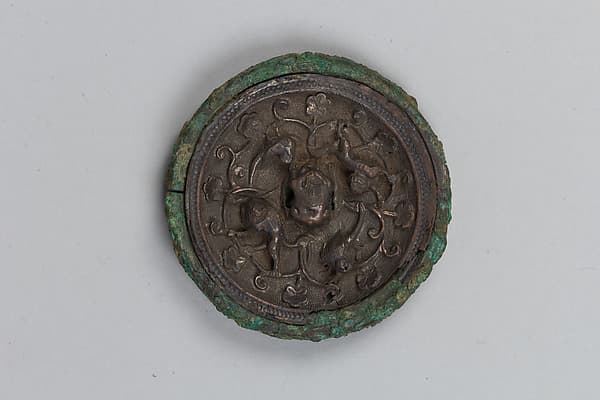 Mirror with birds and lions amid flowers