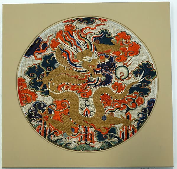 Medallion with dragon amid clouds