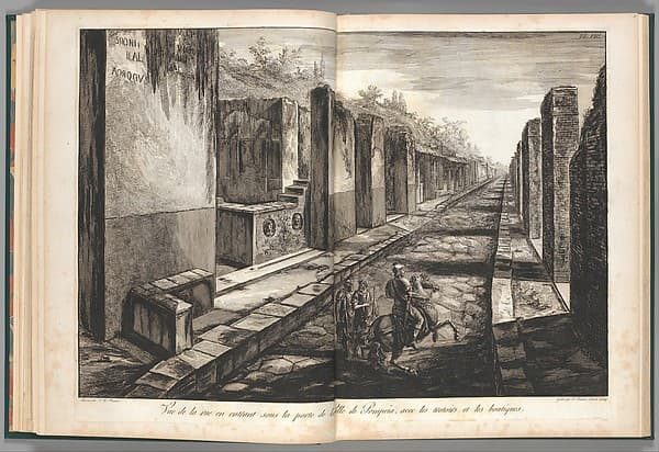 View from the street entering beneath the gateway to the city of Pompeii, with the foot paths and the shops, from "Antiquités de Pompeïa, tome premier, Antiquités de la Grande Grèce..." (Antiquities of Pompeii, volume one, Antiquities of Great Greece...), volume 1, plate 8, by Francesco Piranesi