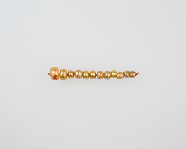String of 12 elongated disc beads