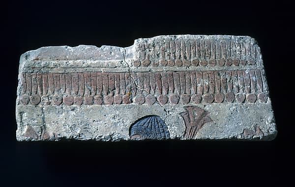Relief with man carrying papyrus bundle