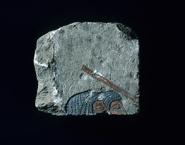 Relief with two heads and a stick