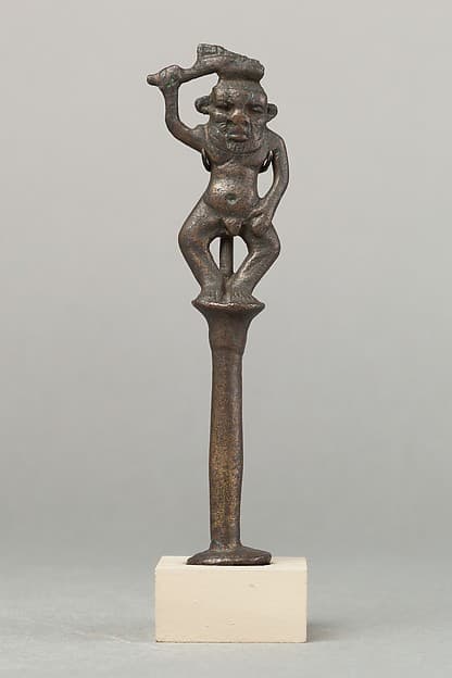 Bes on a column holding a knife