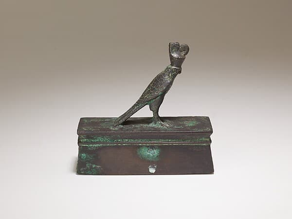 Falcon in double crown surmounting a shrine-shaped box for an animal mummy