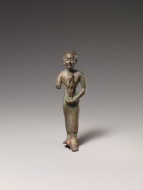 Standing man holding statuette of Nebethetepet or Nehemetaway