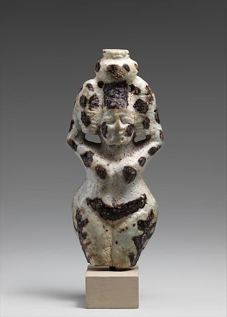 Nude female figure holding a vase on her head