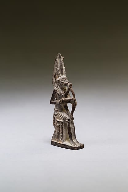 Seated polymorphic figure of jackal-headed archer