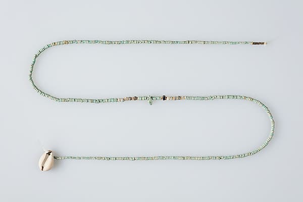 String of beads with shell pendant