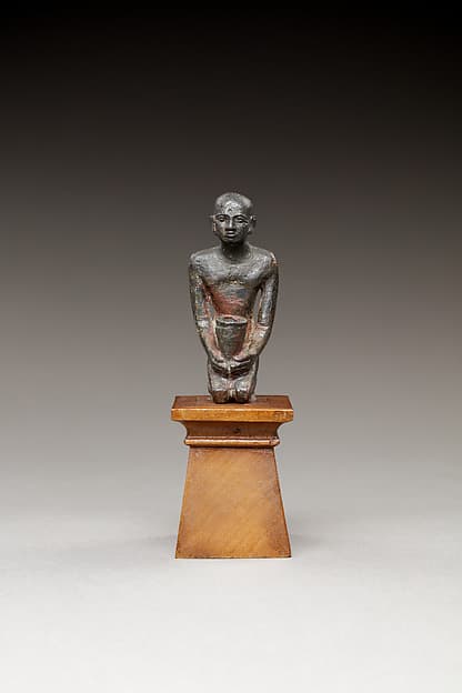 Pediusir kneeling, holding a jar