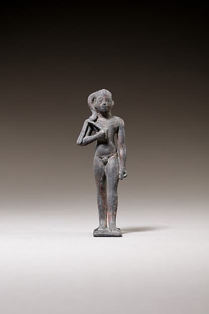 Child god standing and holding a flail