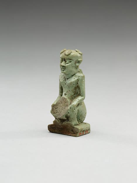 Nude crouching figure wearing a wreath, large phallus broken away