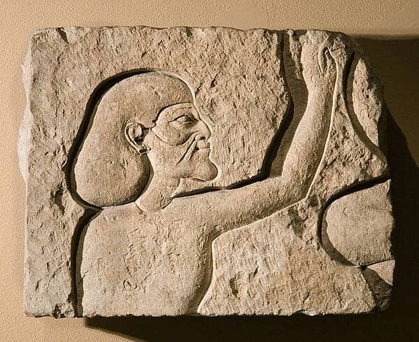 Relief fragment of an Asiatic raising his hands in adoration