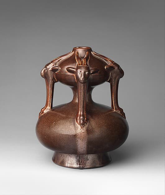 Vase with goat masks, by Christopher Dresser
