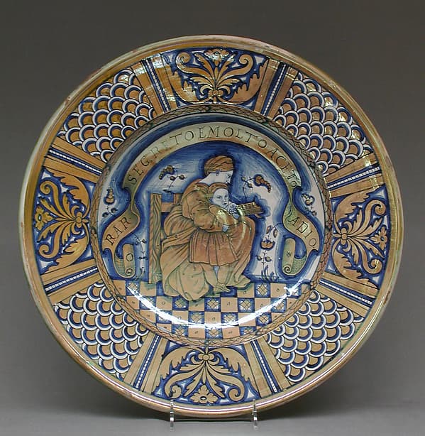 Plate with seated woman reading to a child, by Marco Dente