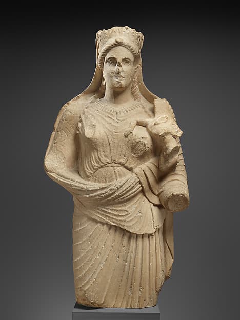 Limestone statue of Aphrodite holding winged Eros
