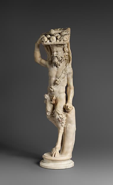 Marble statue of Pan or a satyr with winnowing basket filled with offerings and cultic objects