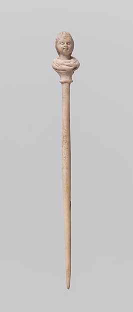 Bone hairpin with female head