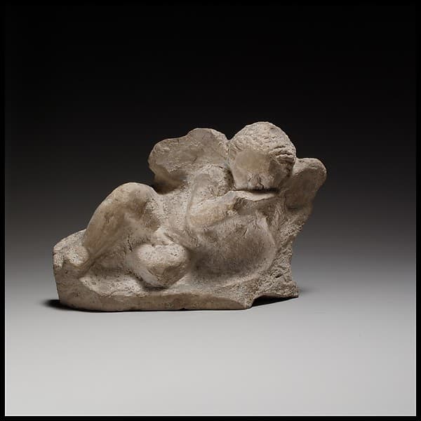 Terracotta statuette of Eros banqueting