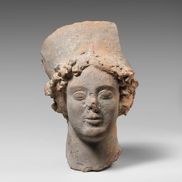 Terracotta head of a woman wearing a high headdress