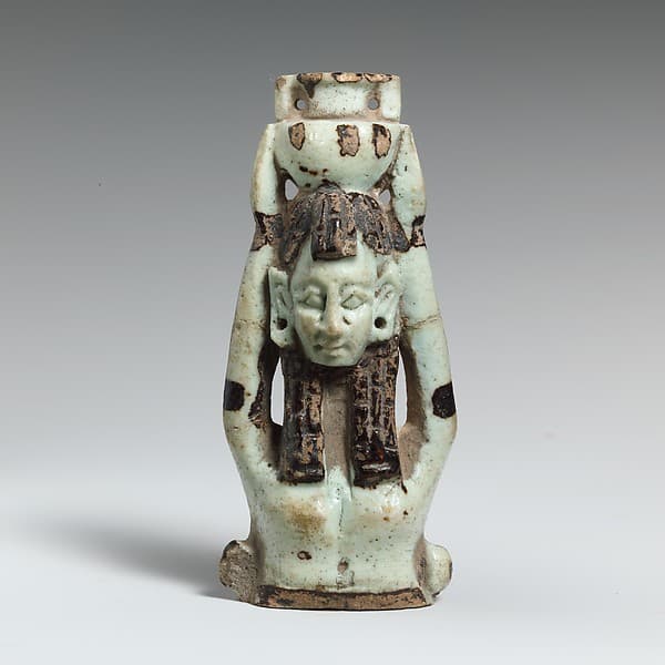 Fragment of a faience statuette of a woman holding a vase on her head