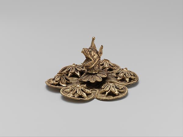 Gold rosette with the head of a griffin