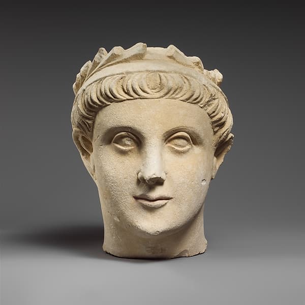 Limestone head of a wreathed youth