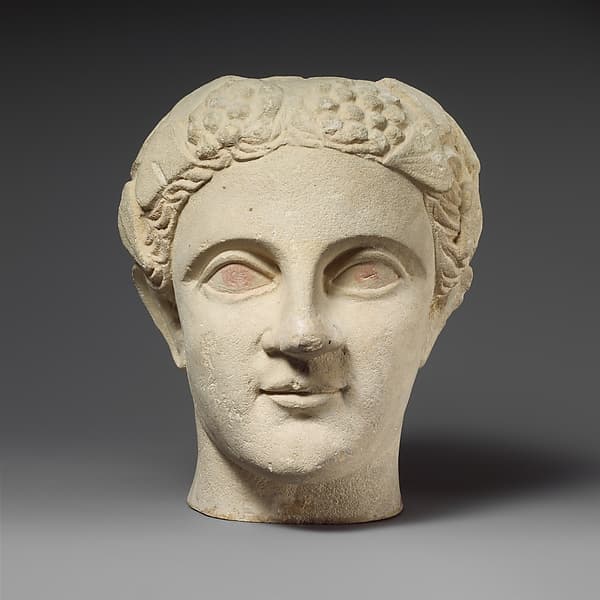 Limestone head of a wreathed youth