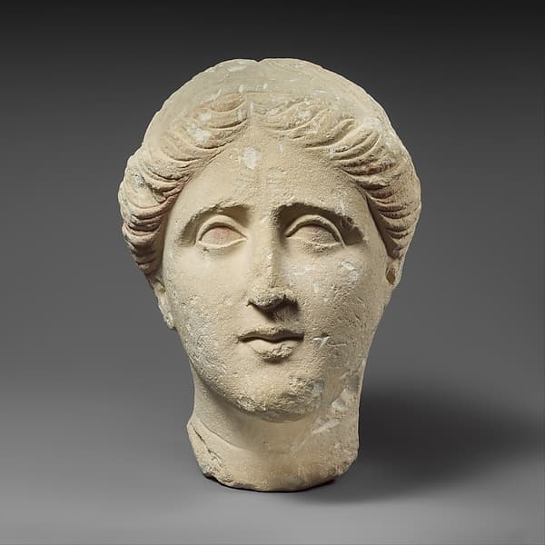 Limestone head of a female votary