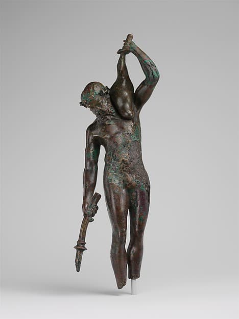 Bronze statuette of a satyr with a torch and wineskin