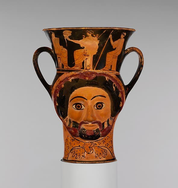 Terracotta kantharos (drinking cup) in the form of the heads of Herakles and of a woman, by Syriskos Painter