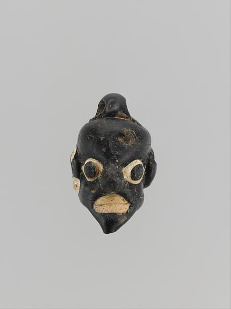 Glass pendant in the form of a demonic mask