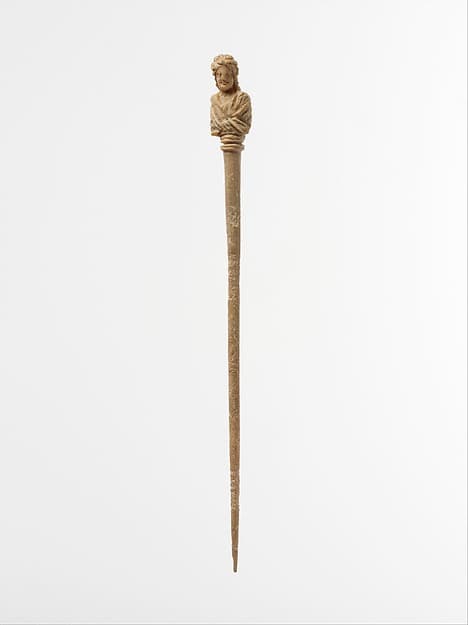 Bone hairpin with bust of a woman