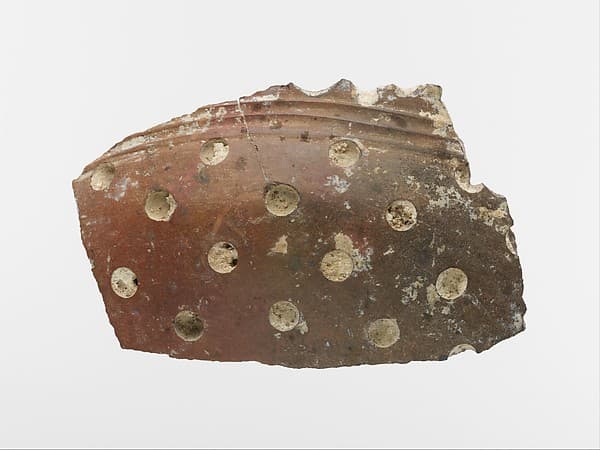 Terracotta vase fragment with white inlay