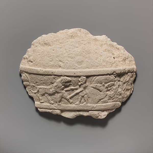 Fragment of a limestone statue of a male votary (worshipper)