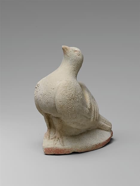 Limestone statue fragment of a left hand resting on a dove