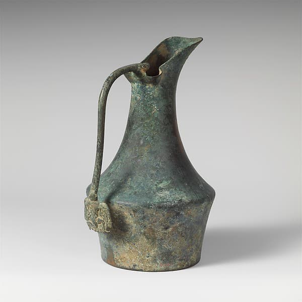 Bronze jug with handle attachment showing running youth
