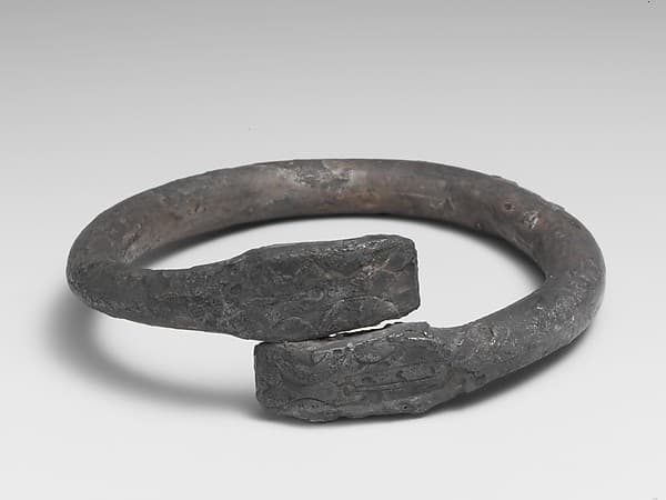 Silver bracelet ending in snake's heads